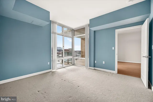 an empty room with windows and city view