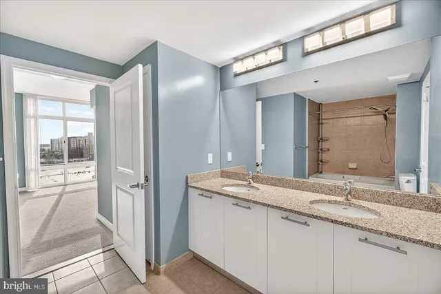 a bathroom with a granite countertop sink mirror and double