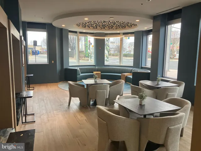 a living room with furniture and large windows