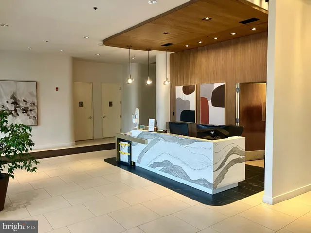 a spacious bedroom with a large bed and a chandelier