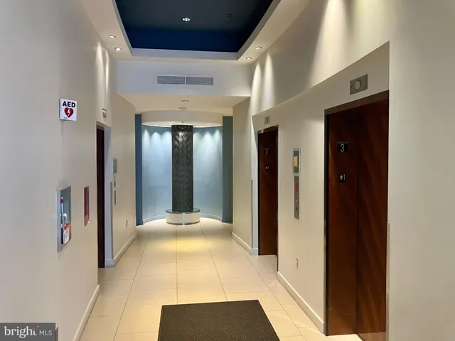 a view of a hallway with wooden floor and entryway