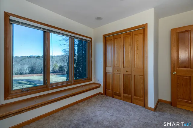 a view of front door with ceiling fan
