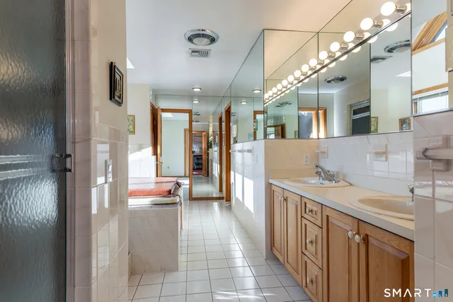 a view of a bathroom with a sink and mirror