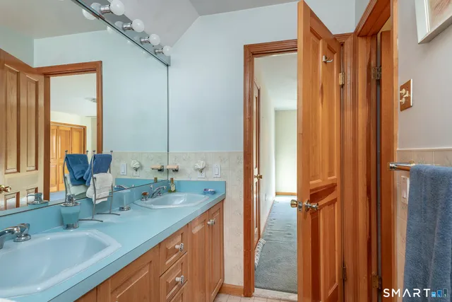 a bathroom with sinks a mirror a vanity and a shower