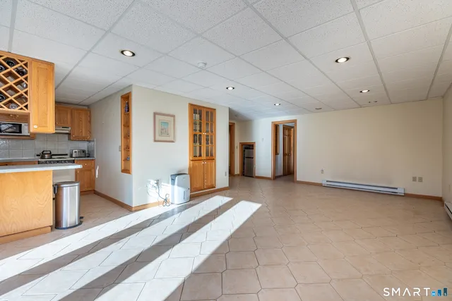 a view of a kitchen with a sink and a refrigerator