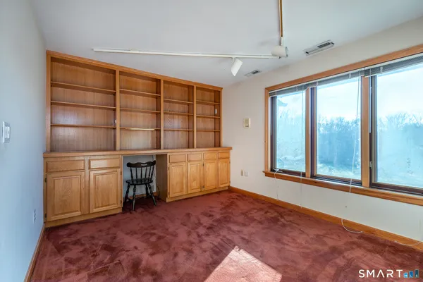 a view of front door with ceiling fan
