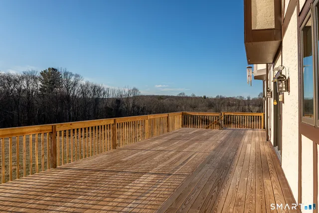a view of balcony with wooden floor and fence