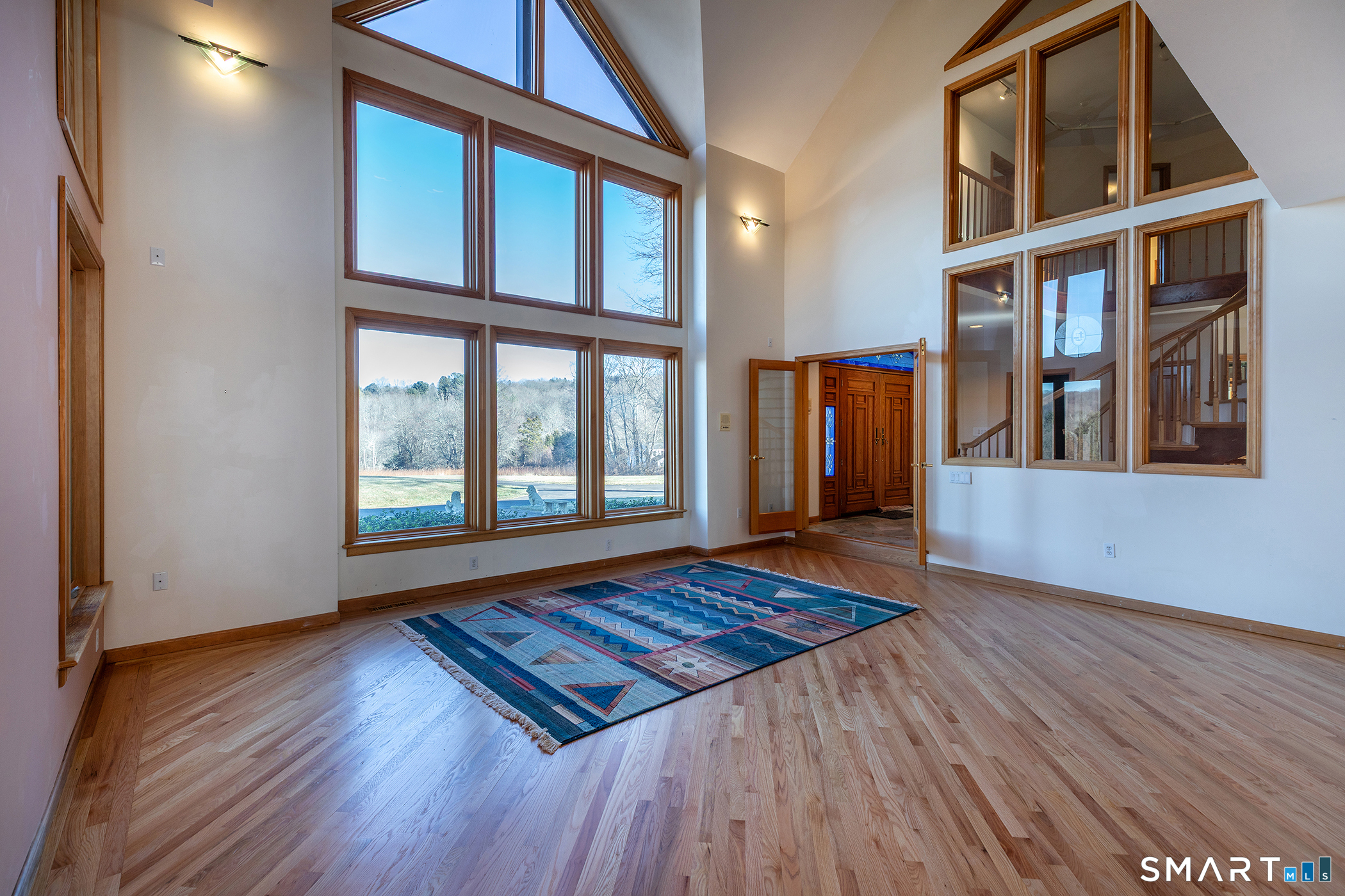 233 Southbury Road Roxbury, CT 06783 - Photo 7 of 38 a view of an empty room with wooden floor and a window