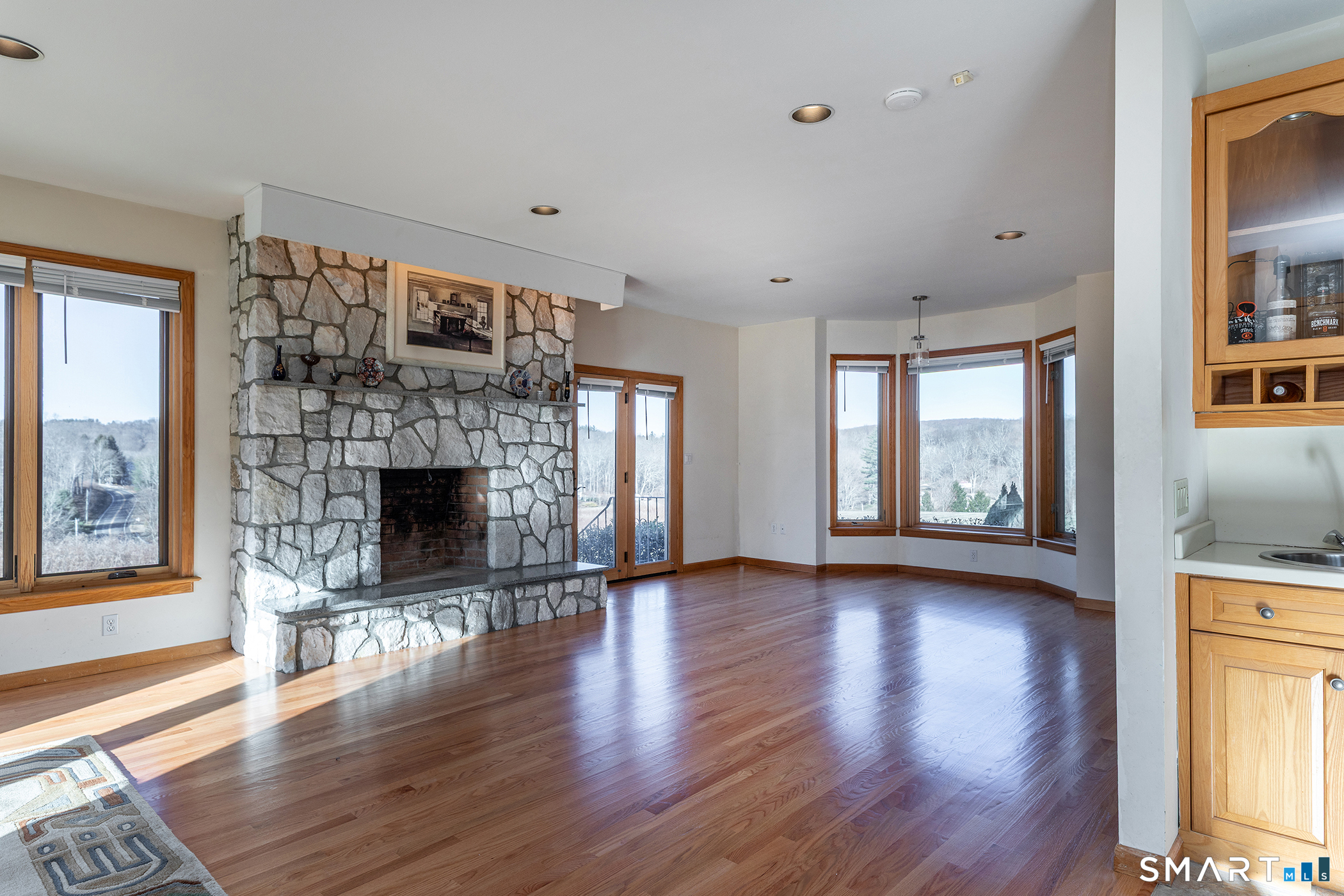 233 Southbury Road Roxbury, CT 06783 - Photo 9 of 38 a view of empty room with wooden floor and fireplace