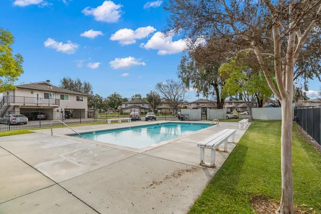 a view of swimming pool with outdoor seating and a garden