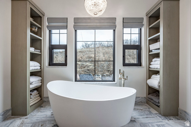 3247 South Mapleton Estates Drive Mapleton, UT 84664 - Photo 43 of 70 Full bath featuring marble tiled flooring, suspended lighting, a freestanding tub, and healthy amount of natural light