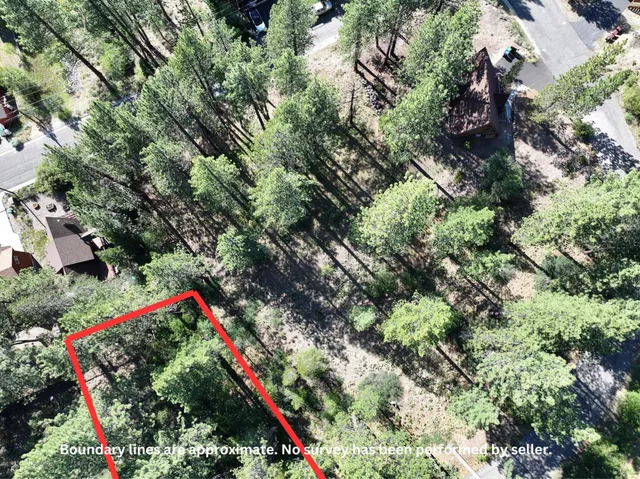 an aerial view of a houses with yard