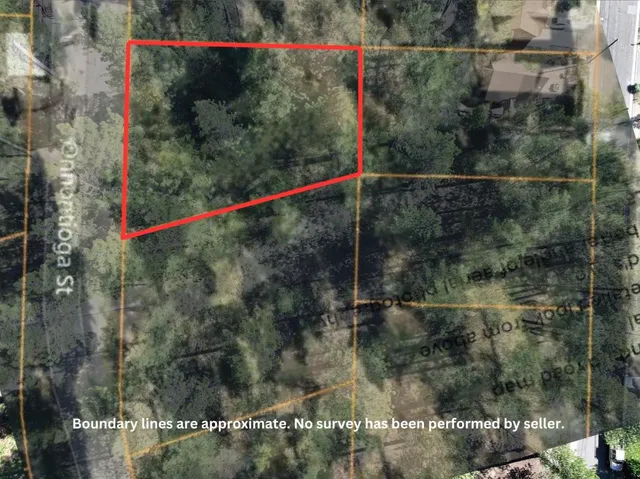 an aerial view of residential house with outdoor space and trees around