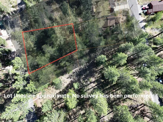 an aerial view of a houses with yard