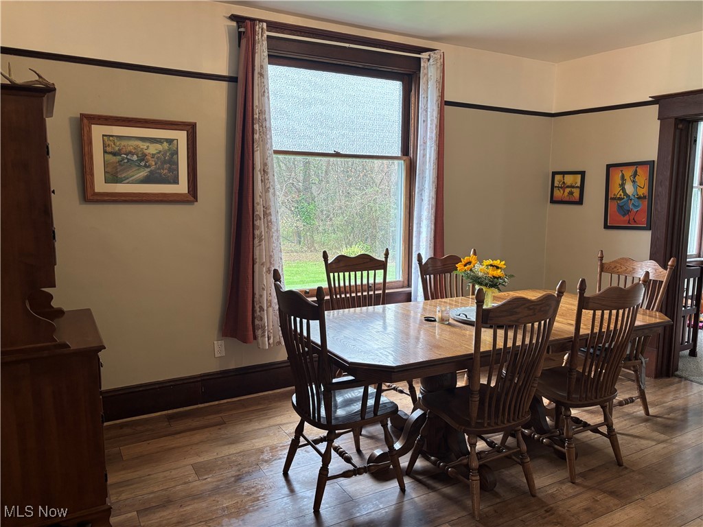 6380 Old River Road Philo, OH 43771 - Photo 13 of 26 Dining space with baseboards and hardwood / wood-style flooring