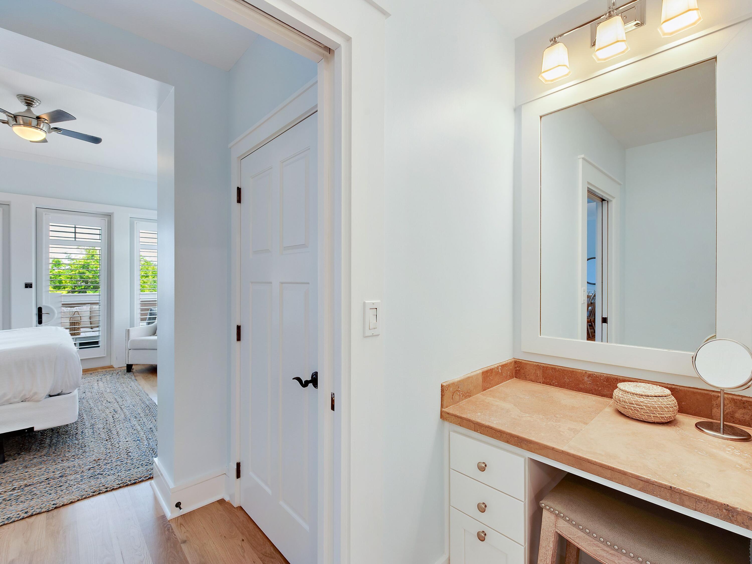 99 Compass Point Way, Unit 202 Watersound, FL 32461 - Photo 11 of 23 a bathroom with a granite countertop sink and a mirror