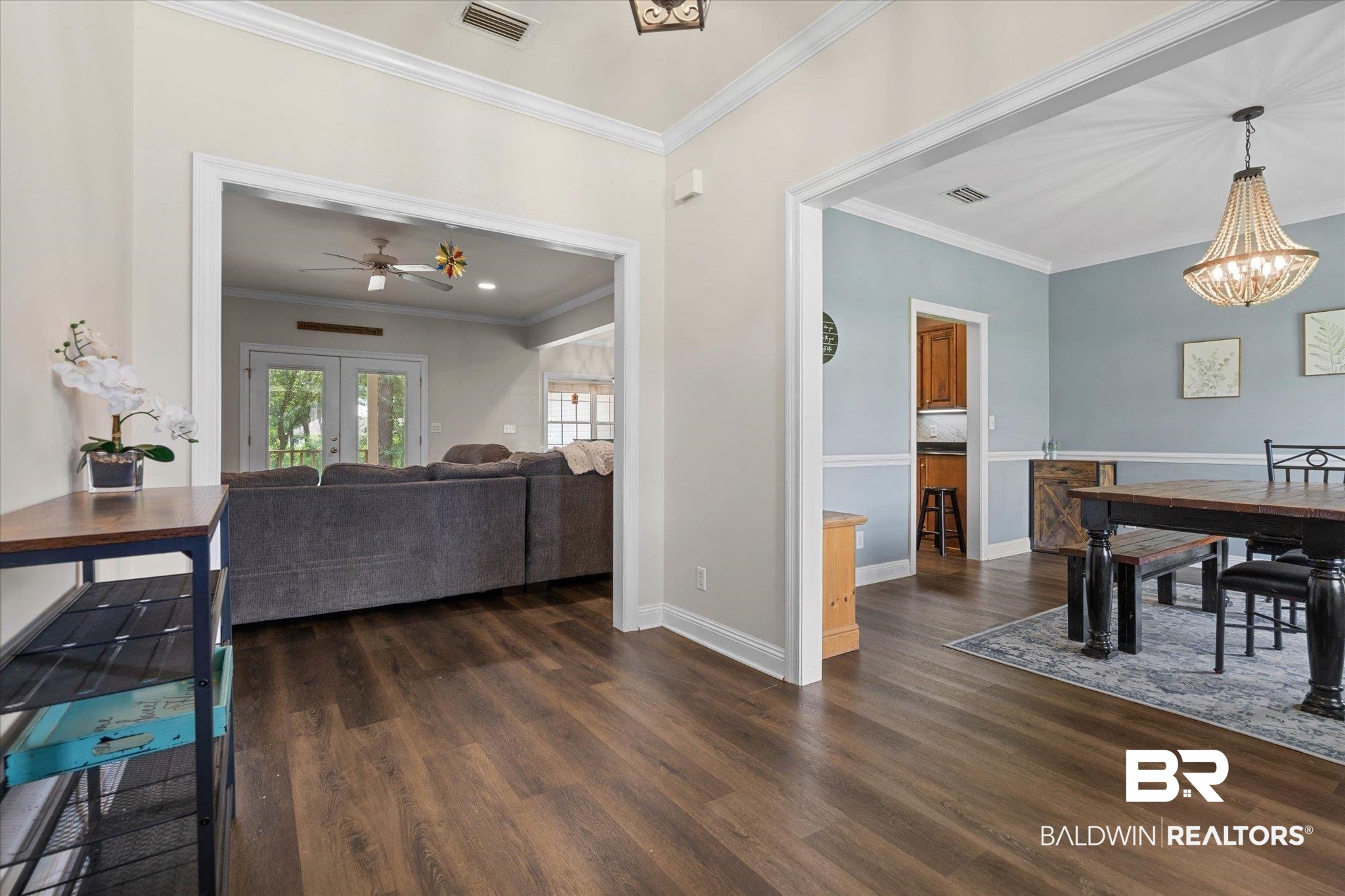 22760 Ridgewood Drive Robertsdale, AL 36567 - Photo 9 of 44 Dining space featuring crown molding, a chandelier, dark wood-type flooring, and ceiling fan
