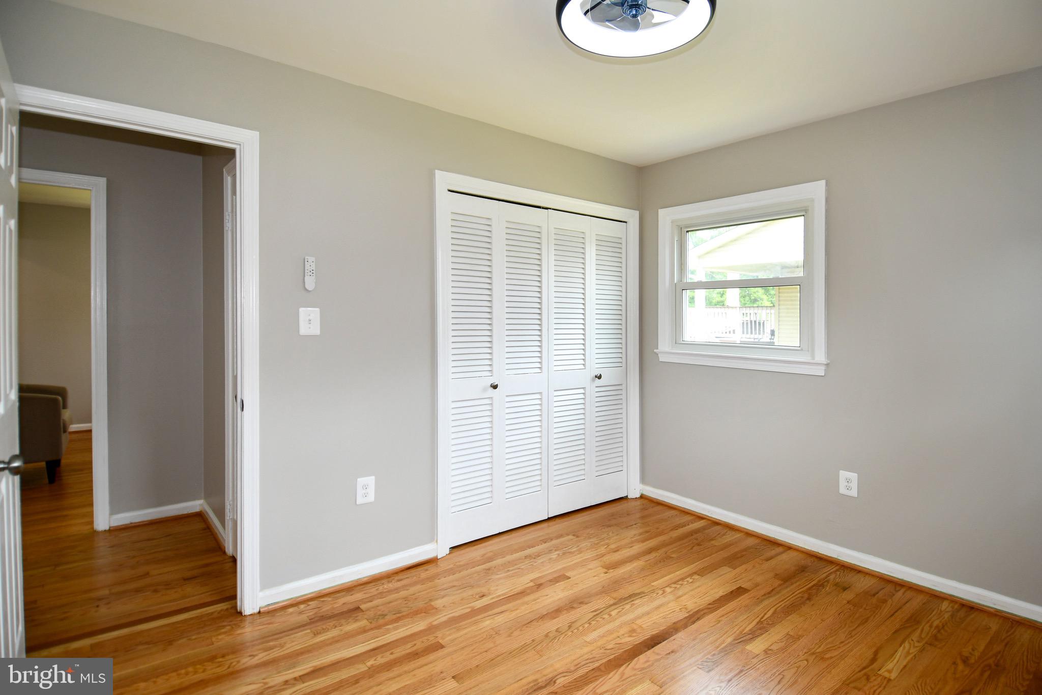 9616 Small Drive Clinton, MD 20735 - Photo 31 of 50 a view of an empty room with wooden floor and a window