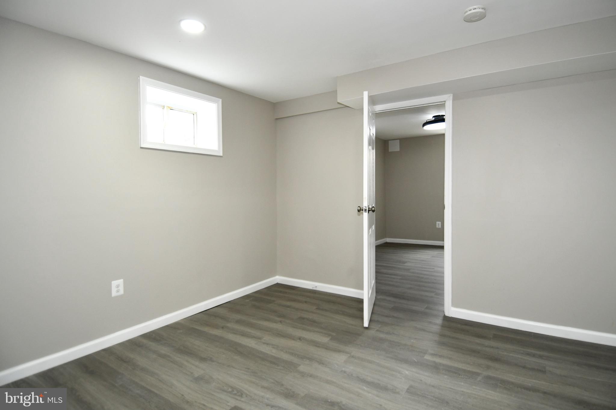 9616 Small Drive Clinton, MD 20735 - Photo 40 of 50 an empty room with wooden floor and windows