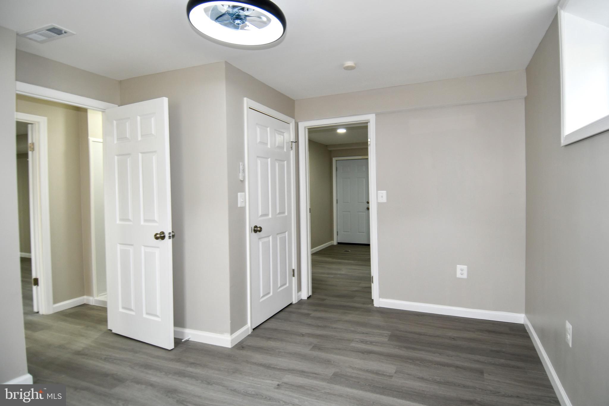 9616 Small Drive Clinton, MD 20735 - Photo 42 of 50 an empty room with wooden floor and windows