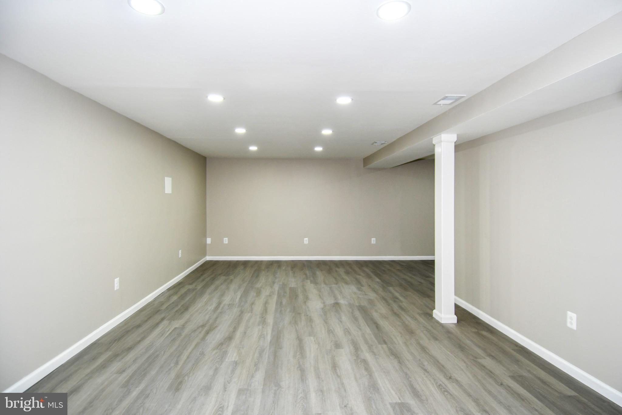 9616 Small Drive Clinton, MD 20735 - Photo 45 of 50 an empty room with wooden floor and windows