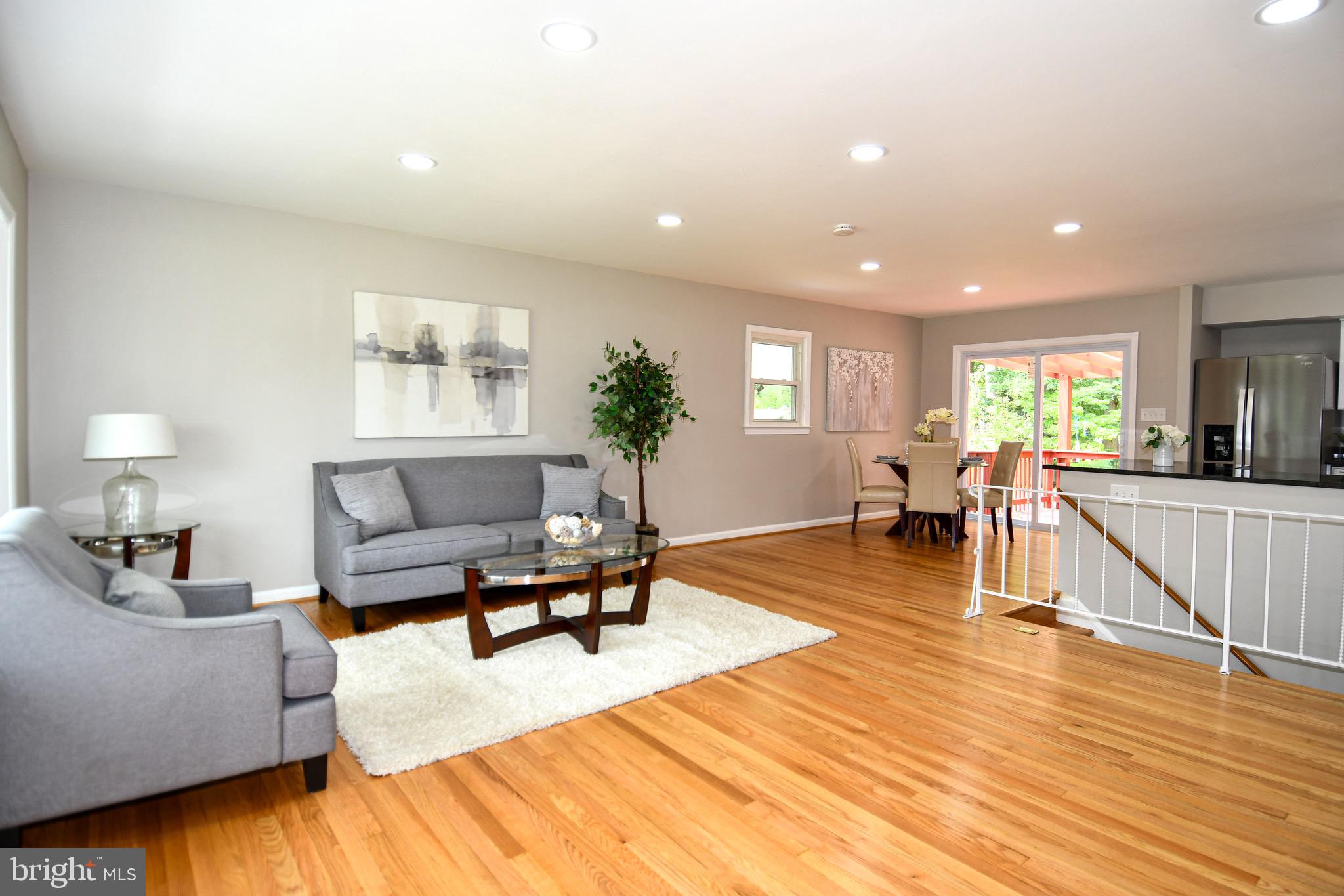 9616 Small Drive Clinton, MD 20735 - Photo 6 of 50 a living room with furniture and a dining table with wooden floor