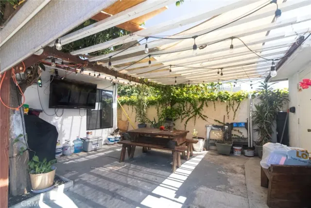 a living room with patio furniture and a flat screen tv