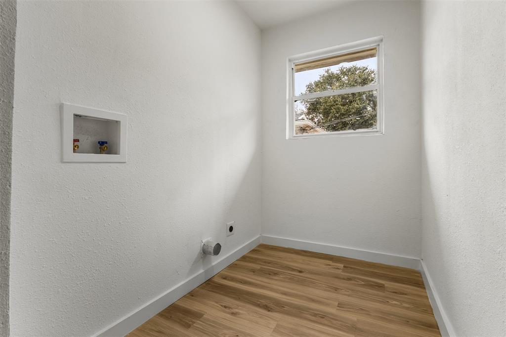 1917 South Vernon Avenue Dallas, TX 75224 - Photo 27 of 28 Dedicated utility room featuring wood-finish flooring, a white-framed window, and built-in washing machine hookups