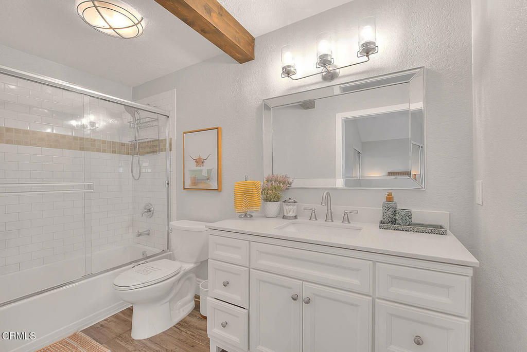 420 West 3rd Street San Dimas, CA 91773 - Photo 11 of 19 a bathroom with a granite countertop toilet sink and a mirror