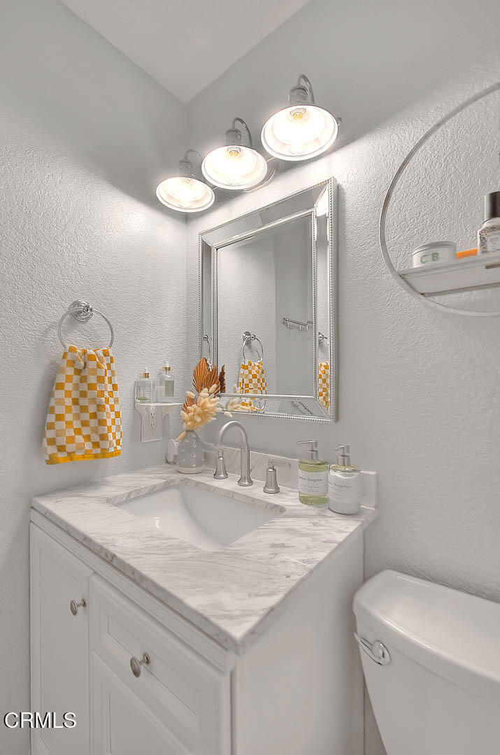 420 West 3rd Street San Dimas, CA 91773 - Photo 15 of 19 a bathroom with a granite countertop sink and a mirror