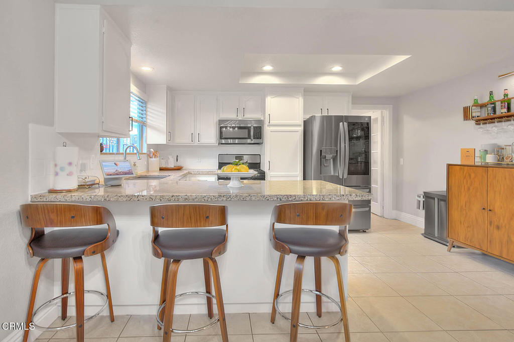 420 West 3rd Street San Dimas, CA 91773 - Photo 6 of 19 a kitchen with stainless steel appliances granite countertop counter top space and a cabinets