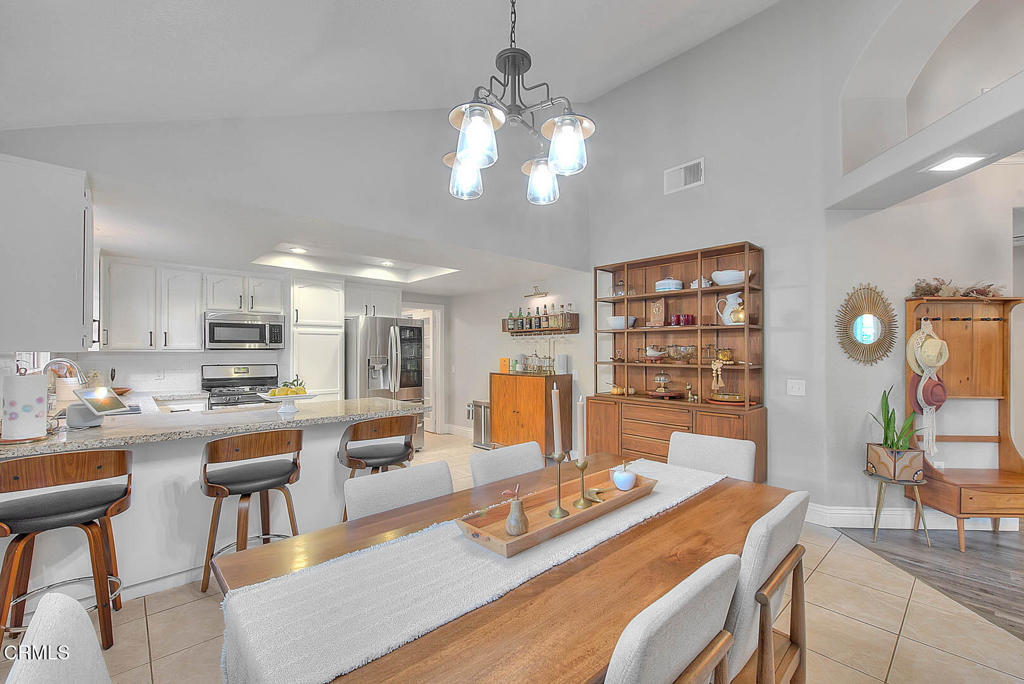 420 West 3rd Street San Dimas, CA 91773 - Photo 7 of 19 a view of a dining room and livingroom with furniture wooden floor and a rug