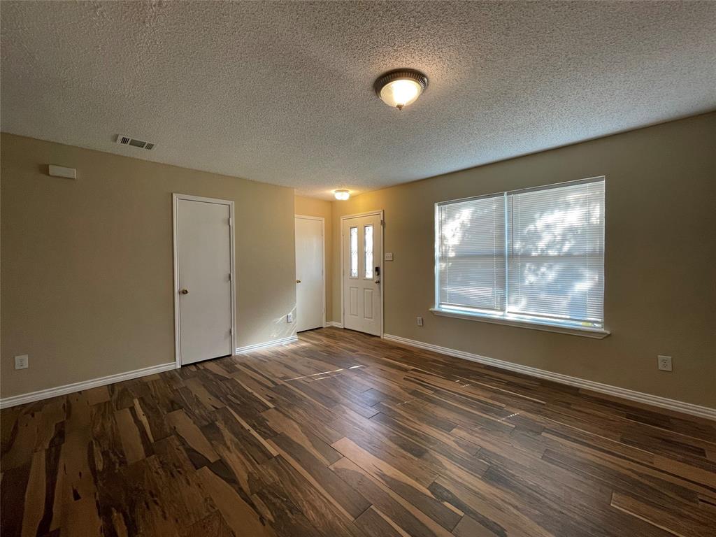 4855 Diamond Trace Trail Fort Worth, TX 76244 - Photo 10 of 21 a view of an empty room with wooden floor and a window