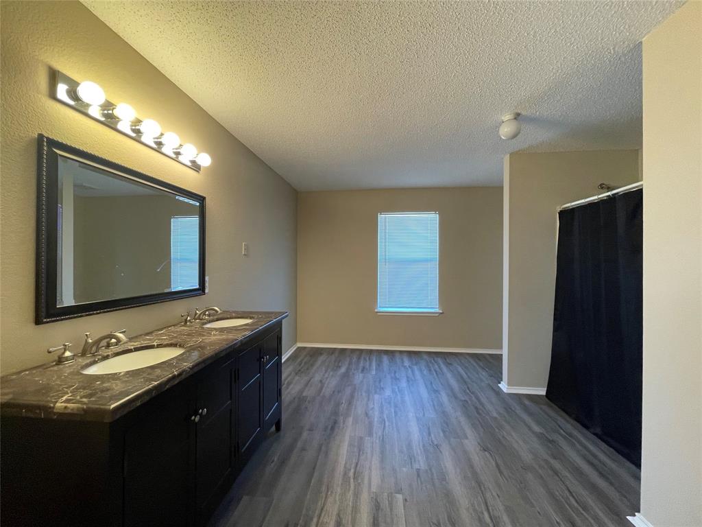 4855 Diamond Trace Trail Fort Worth, TX 76244 - Photo 17 of 21 a bathroom with a double vanity sink and a mirror