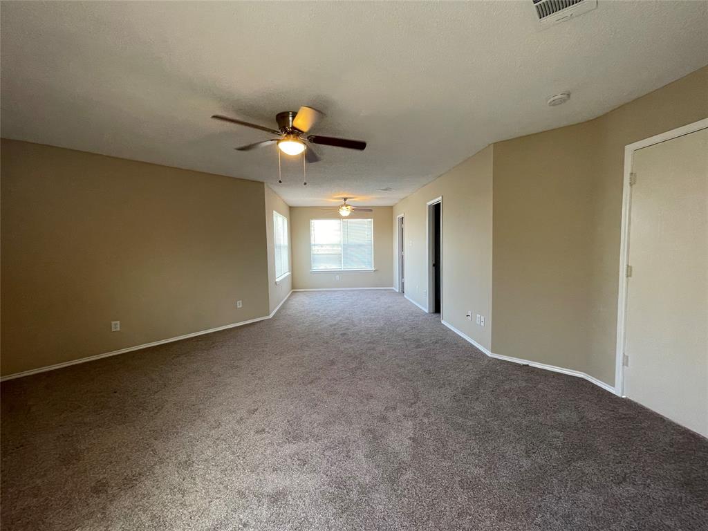 4855 Diamond Trace Trail Fort Worth, TX 76244 - Photo 19 of 21 a view of a livingroom with a ceiling fan and window