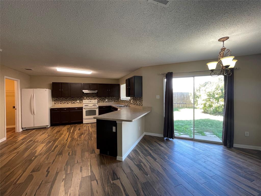 4855 Diamond Trace Trail Fort Worth, TX 76244 - Photo 5 of 21 a large kitchen with wooden floors and stainless steel appliances