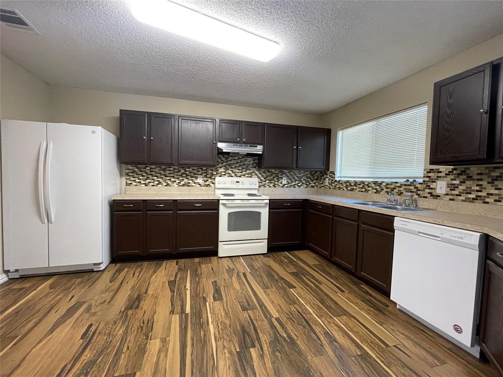 4855 Diamond Trace Trail Fort Worth, TX 76244 - Photo 6 of 21 a kitchen with stainless steel appliances granite countertop a stove a sink and a refrigerator
