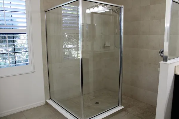 a bathroom with a shower and a sink