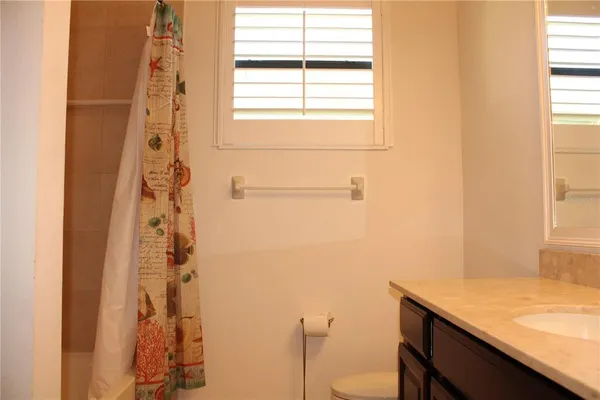 a front view of a house with a tree