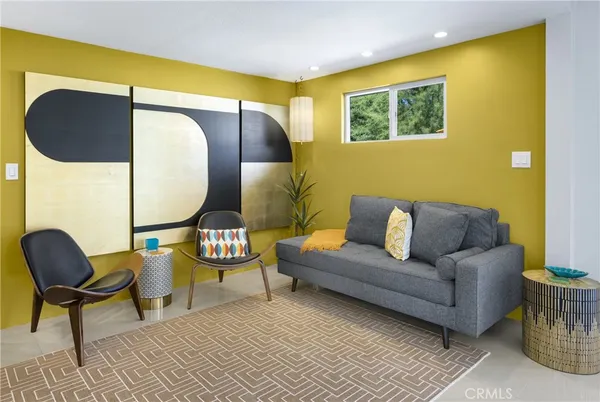 a living room with furniture and a lamp