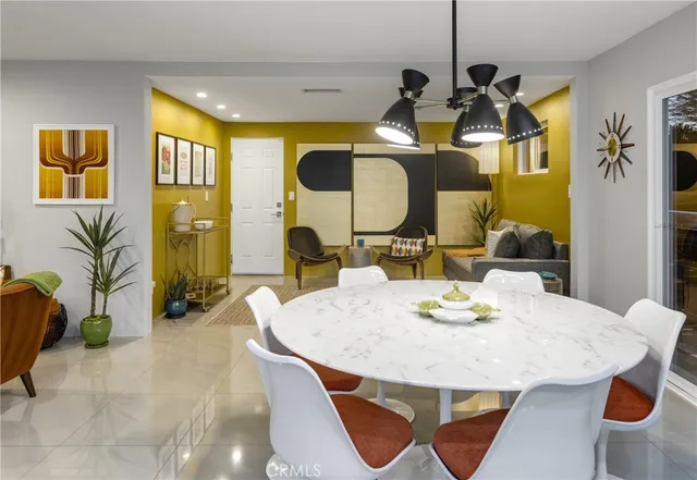 a large kitchen with a table and chairs