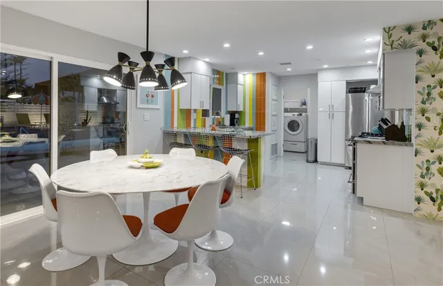 a very nice looking kitchen with a large window cabinets and stainless steel appliances