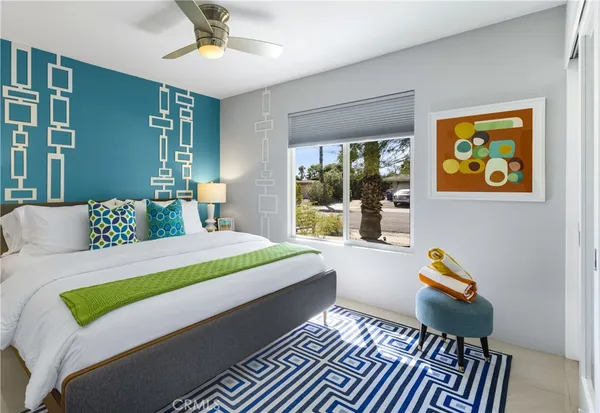a bedroom with a bed and a lamp with mirror