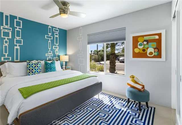 a bedroom with a bed and a lamp with mirror