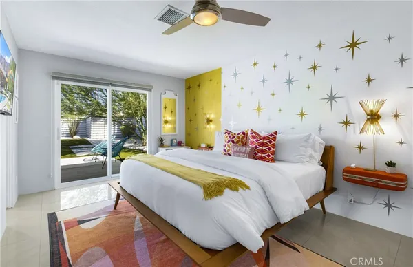 a bed sitting in a bedroom next to a window with painted walls