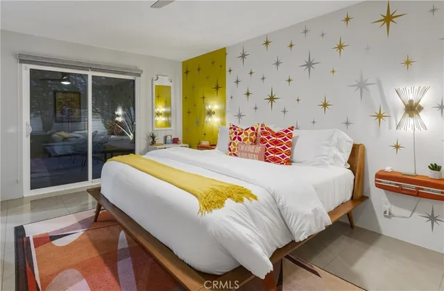 a bedroom with a bed and a painting on the wall