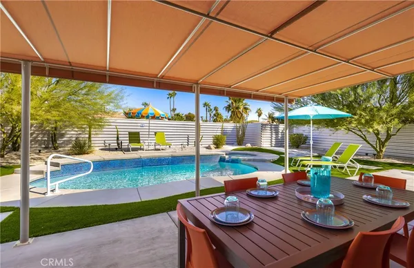 a view of a house with swimming pool and sitting area