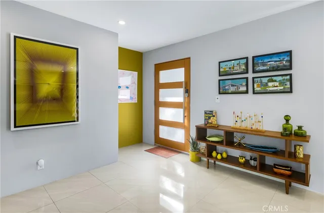 a living room with furniture and painting on the wall