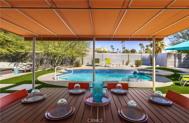 a view of a house with swimming pool and sitting area