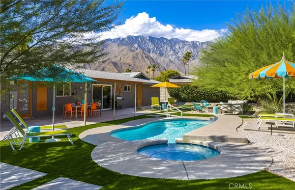 a view of a patio with swimming pool table and chairs
